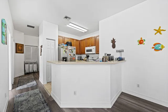 a view of kitchen with furniture and refrigerator