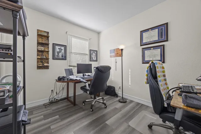 a view of a workspace with furniture and a window