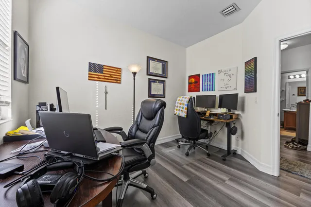 a view of a workspace with furniture and a window