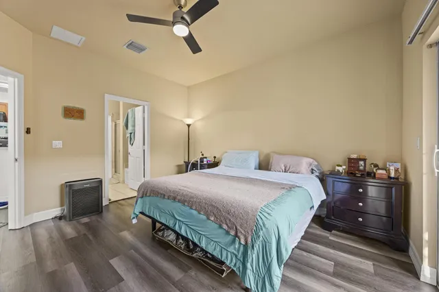 a bedroom with a bed and wooden floor