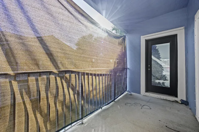 a view of a hallway with wooden floor and entryway