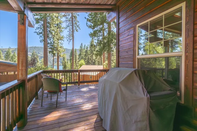a balcony with chairs and wooden floor