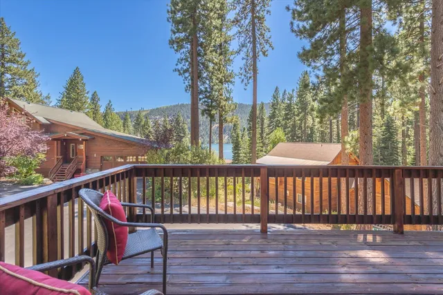 a balcony with wooden floor and fence