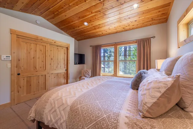 a bed sitting in a bedroom next to a window