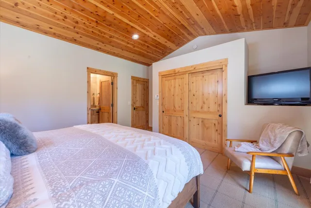 a bedroom with a bed and a chair