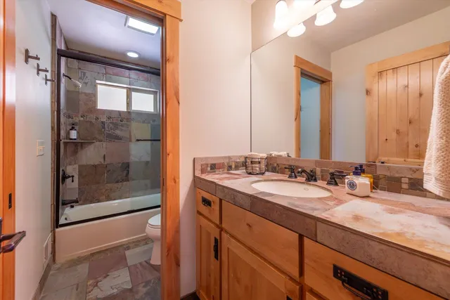 a bathroom with a double vanity sink and mirror