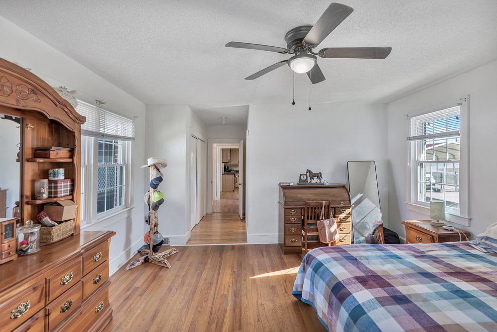 105 West Church Street Iva, SC 29655 - Photo 15 of 25 This spacious bedroom offers ample natural light and elegant hardwood floors.
