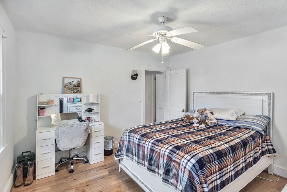 105 West Church Street Iva, SC 29655 - Photo 16 of 25 This cozy bedroom features warm wood flooring and a refreshing ceiling fan.