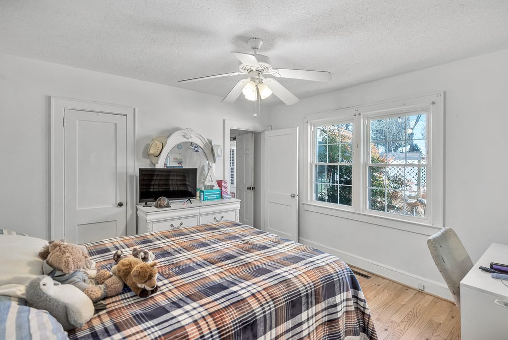105 West Church Street Iva, SC 29655 - Photo 17 of 25 This bright and airy bedroom features beautiful hardwood flooring and a refreshing ceiling fan.