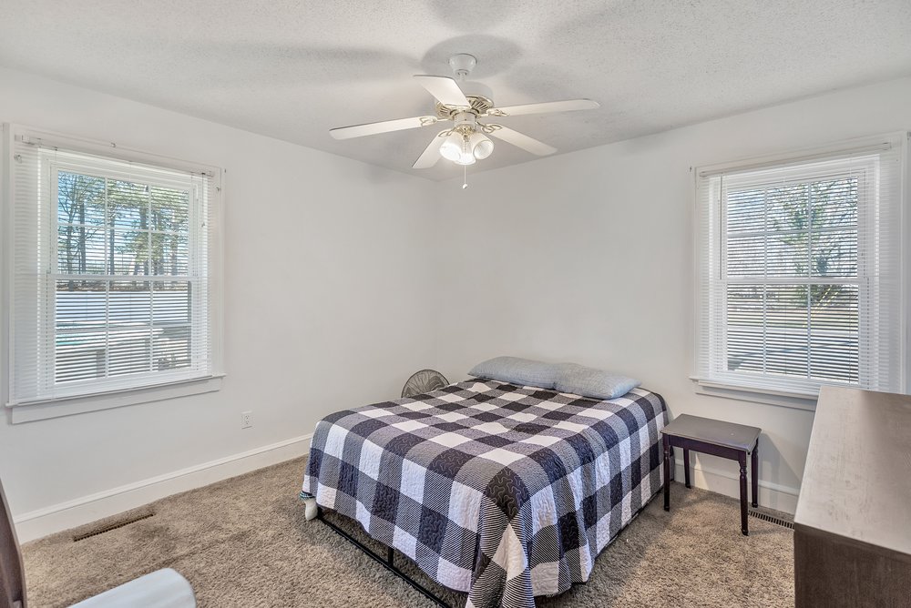 105 West Church Street Iva, SC 29655 - Photo 18 of 25 This bright and airy bedroom features soft carpeting and abundant natural light through multiple windows.