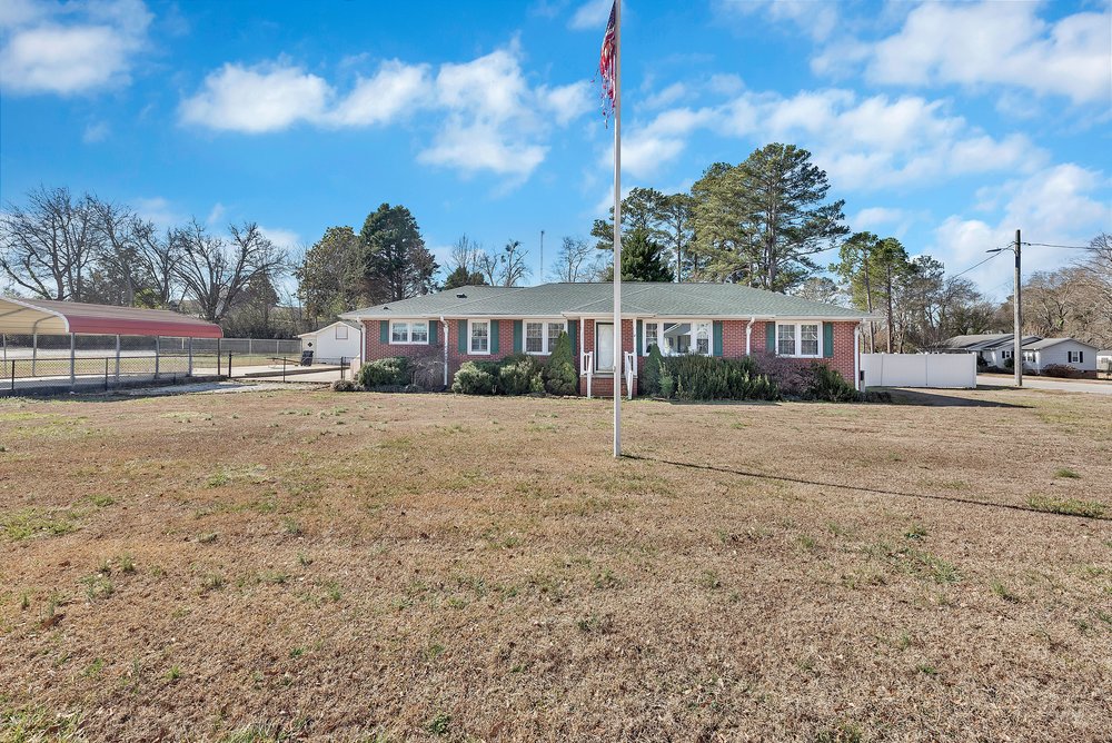 105 West Church Street Iva, SC 29655 - Photo 24 of 25 This brick ranch offers a classic facade with a welcoming front entrance and expansive yard.