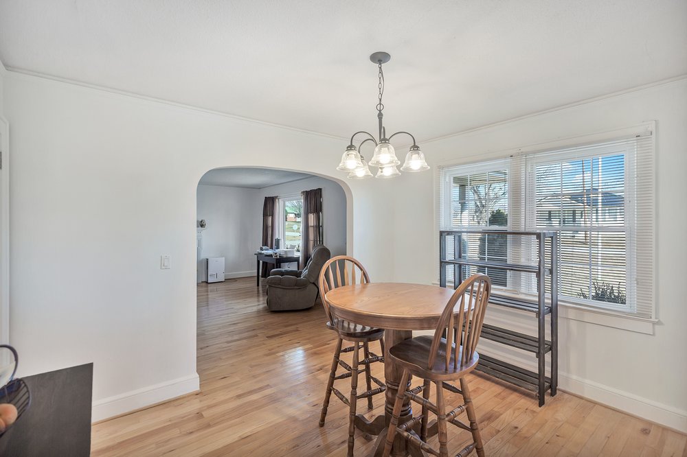105 West Church Street Iva, SC 29655 - Photo 5 of 25 This bright dining area features an elegant chandelier and beautiful hardwood flooring.