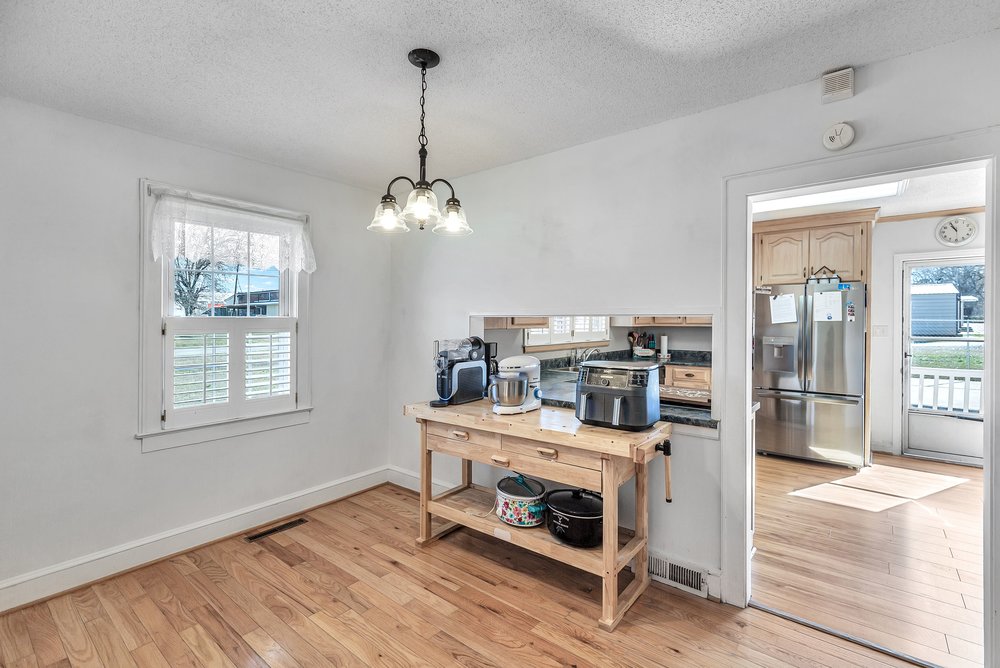 105 West Church Street Iva, SC 29655 - Photo 6 of 25 This bright space features natural light, beautiful wood flooring, and a convenient pass-through to the kitchen.