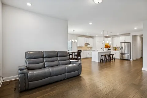 a living room with furniture and kitchen view