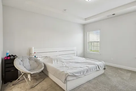 a bedroom with a bed and a table chair
