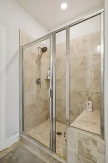 a bathroom with a glass shower door