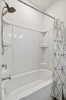 a bathroom with a bathtub and a shower