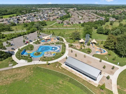 an aerial view of a house with garden space and outdoor seating