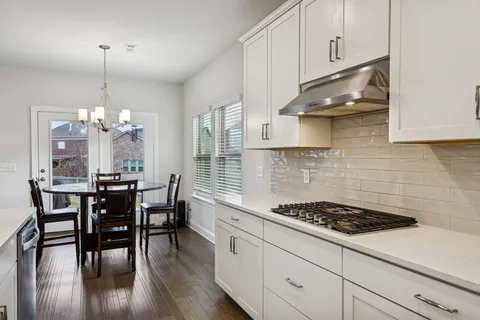 a kitchen with a dining table and cabinets