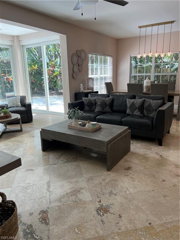 901 Egrets Run, Unit 4102 Naples, FL 34108 - Photo 11 of 27 a living room with furniture and a large window
