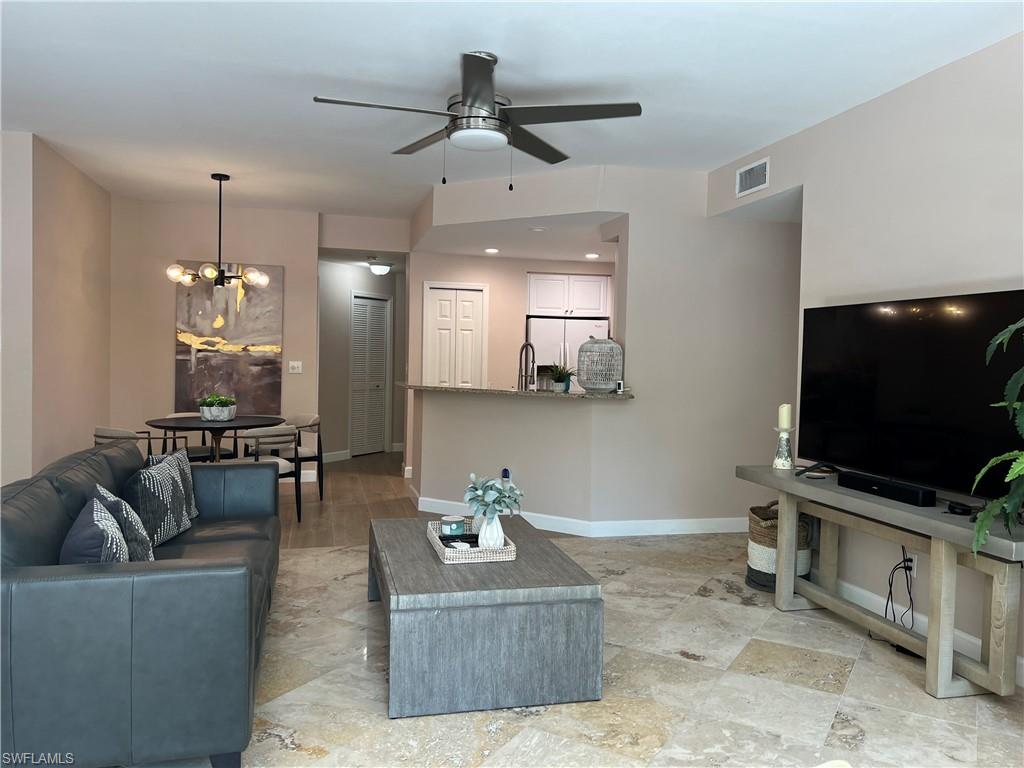 901 Egrets Run, Unit 4102 Naples, FL 34108 - Photo 14 of 27 a living room with furniture and a flat screen tv