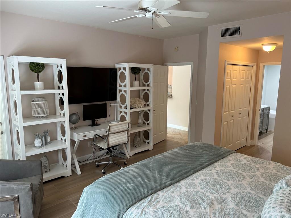 901 Egrets Run, Unit 4102 Naples, FL 34108 - Photo 16 of 27 a bedroom with a workspace and a couch