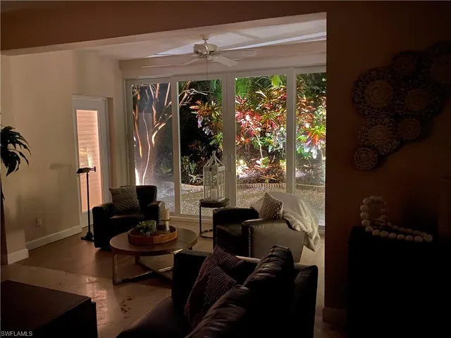 a view of a yard with plants and trees