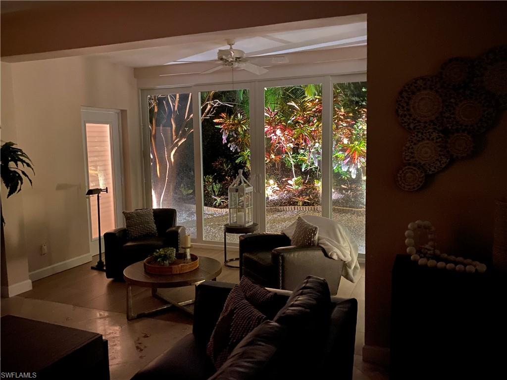 901 Egrets Run, Unit 4102 Naples, FL 34108 - Photo 23 of 27 a living room with furniture and a large window