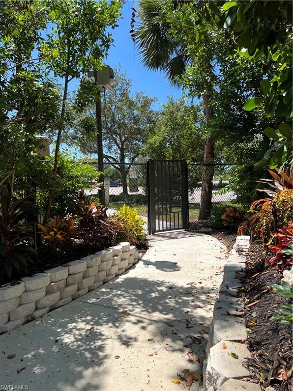901 Egrets Run, Unit 4102 Naples, FL 34108 - Photo 24 of 27 a view of a yard with plants and trees