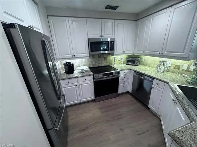a kitchen with a refrigerator stove and microwave