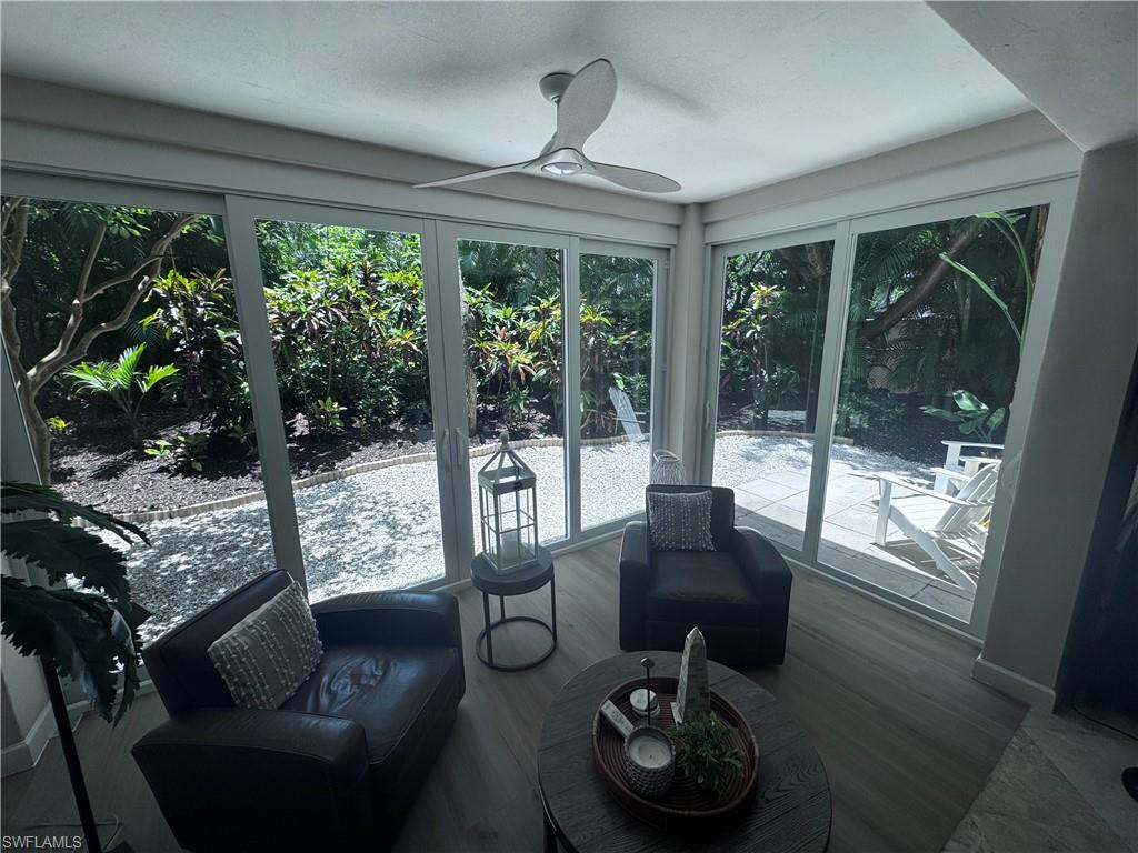 901 Egrets Run, Unit 4102 Naples, FL 34108 - Photo 27 of 27 a living room with furniture and a floor to ceiling window