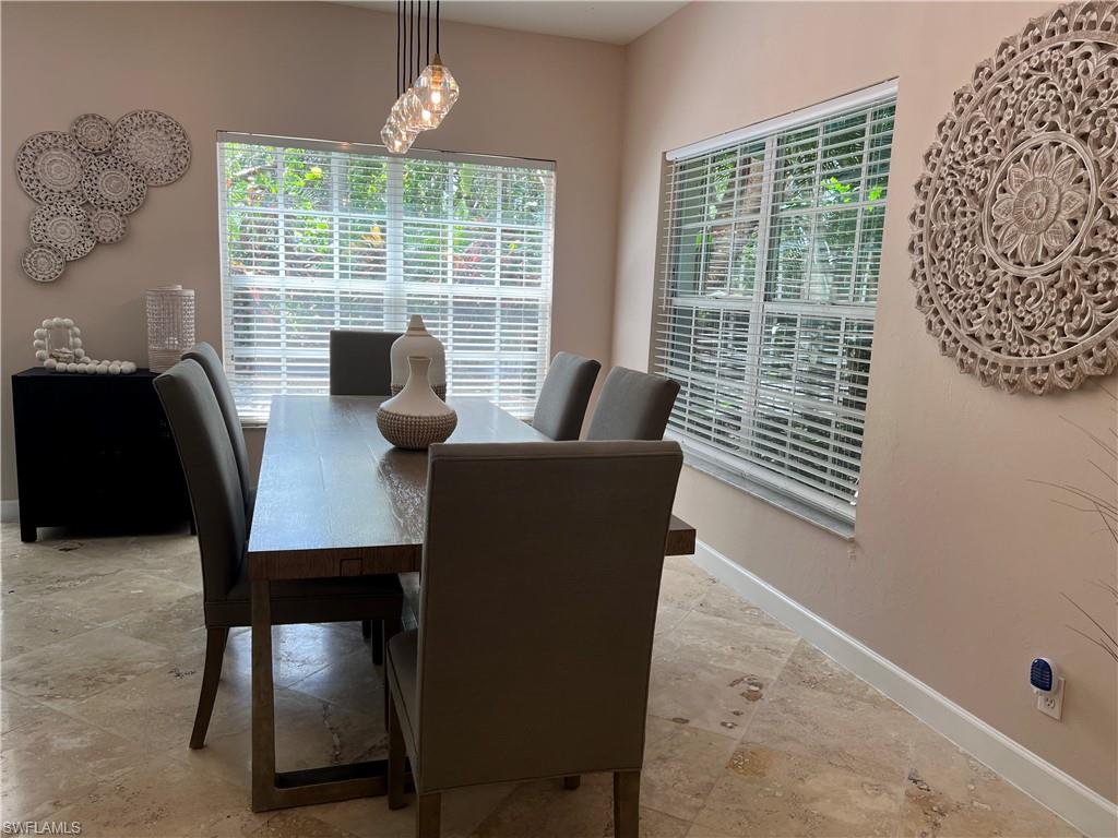 901 Egrets Run, Unit 4102 Naples, FL 34108 - Photo 3 of 27 a view of a dining room with furniture window and outside view