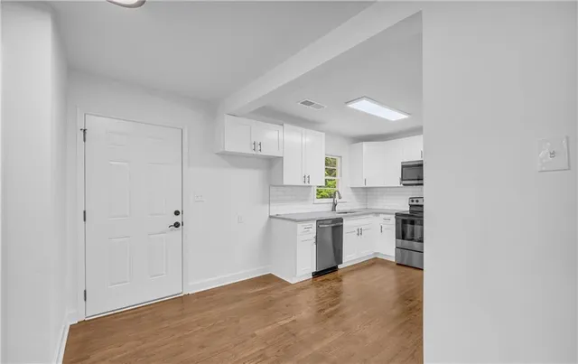 wooden floor in an empty room with a window