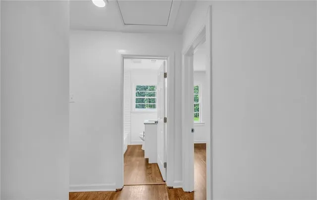 a view of an empty room with wooden floor