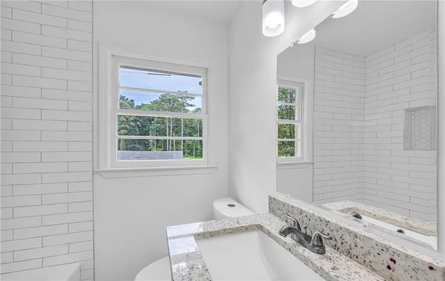 a bathroom with a sink a bathtub and window