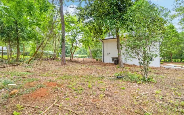 a view of a white house with a large space
