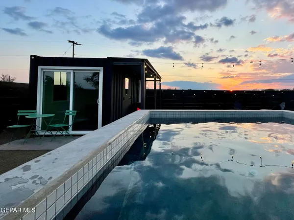 a view of swimming pool with an outdoor seating
