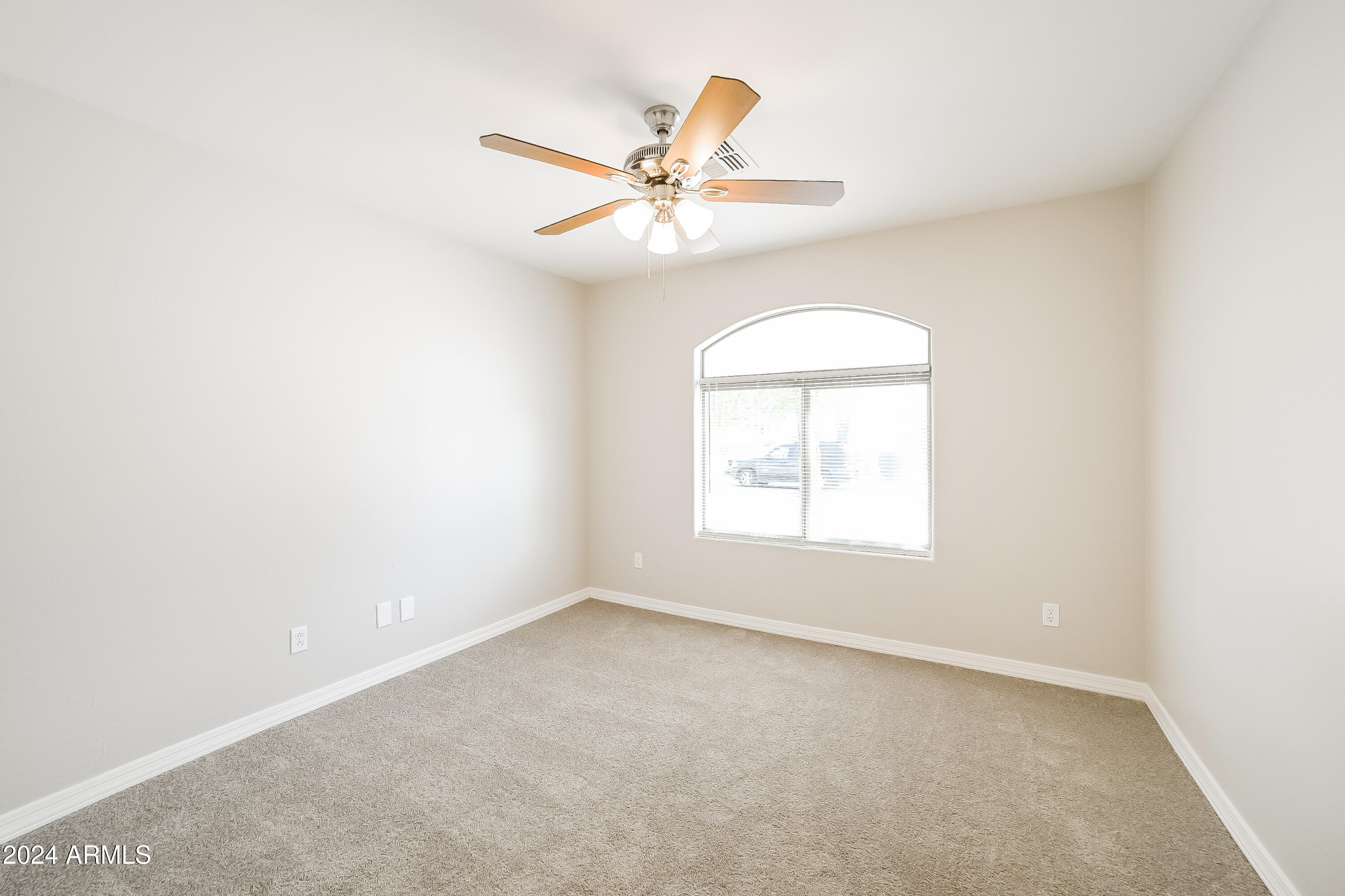 41402 Hopper Drive Maricopa, AZ 85138 - Photo 10 of 16 an empty room with a window and a fan