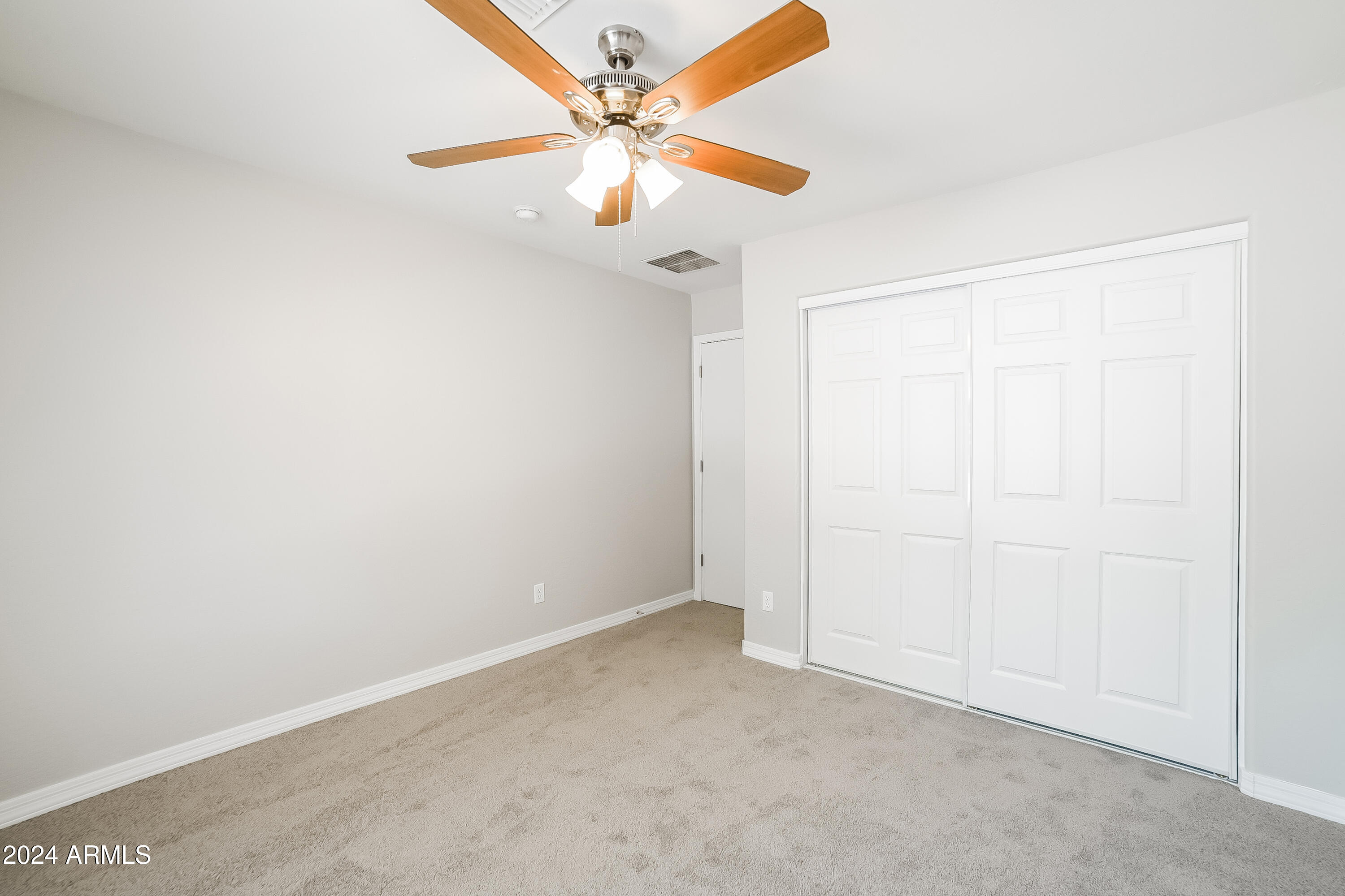 41402 Hopper Drive Maricopa, AZ 85138 - Photo 11 of 16 an empty room with a fan & a window