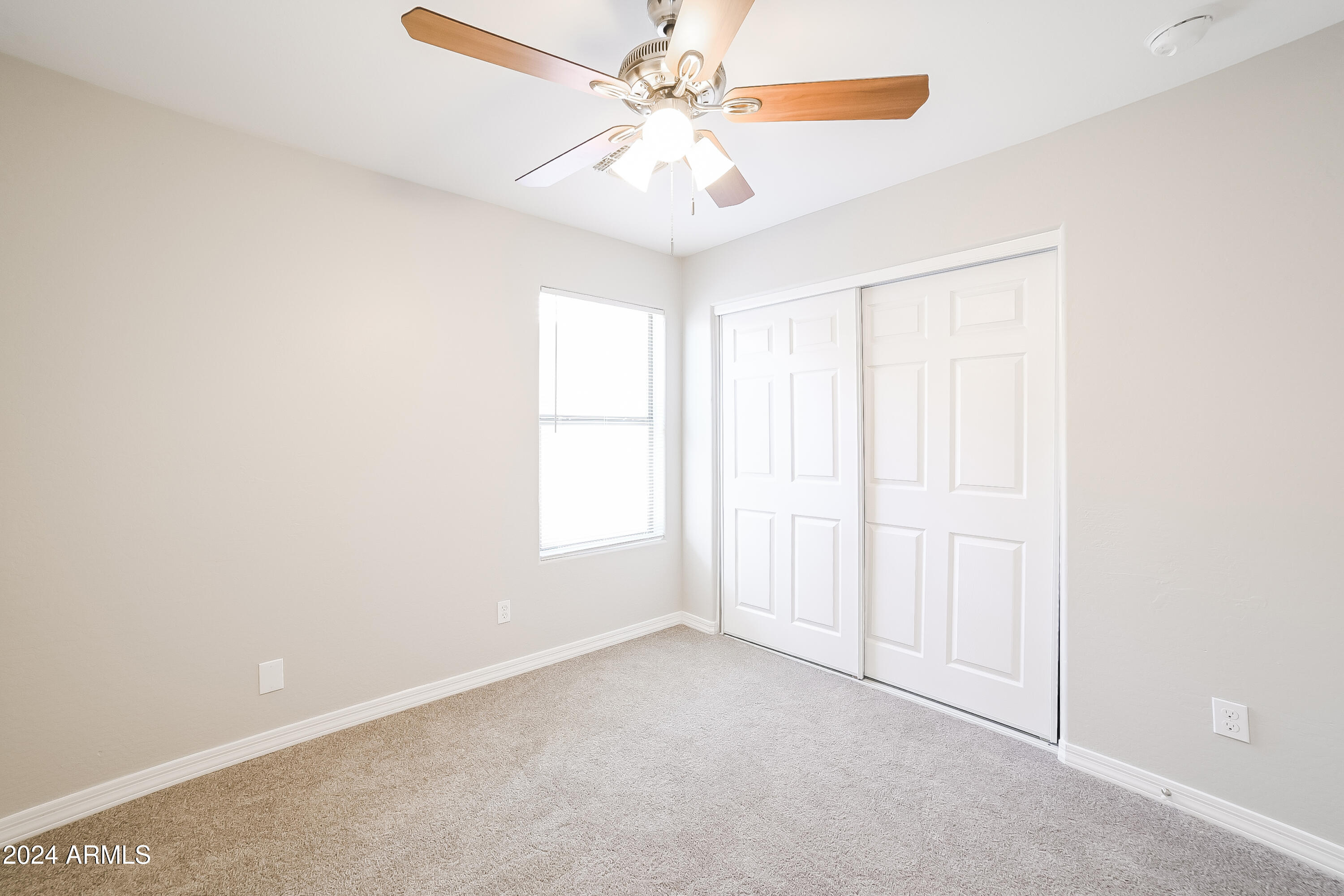 41402 Hopper Drive Maricopa, AZ 85138 - Photo 12 of 16 an empty room with windows and fan