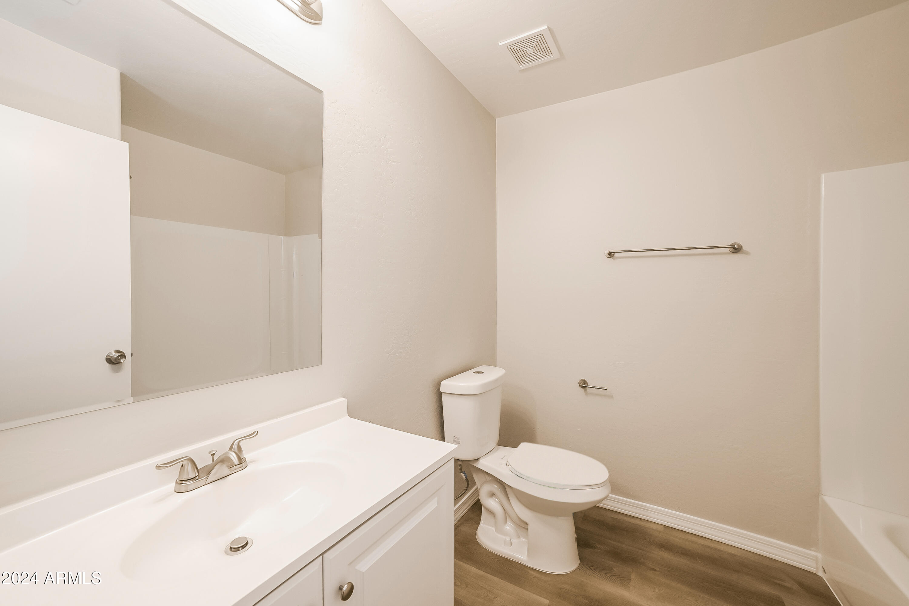 41402 Hopper Drive Maricopa, AZ 85138 - Photo 14 of 16 a bathroom with a toilet a sink and a mirror