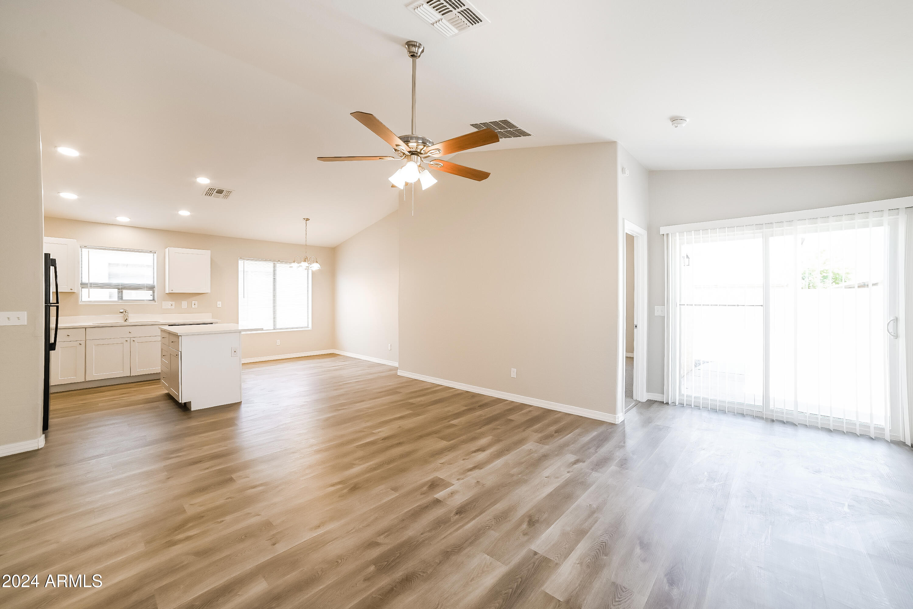 41402 Hopper Drive Maricopa, AZ 85138 - Photo 2 of 16 a view of an empty room with a kitchen