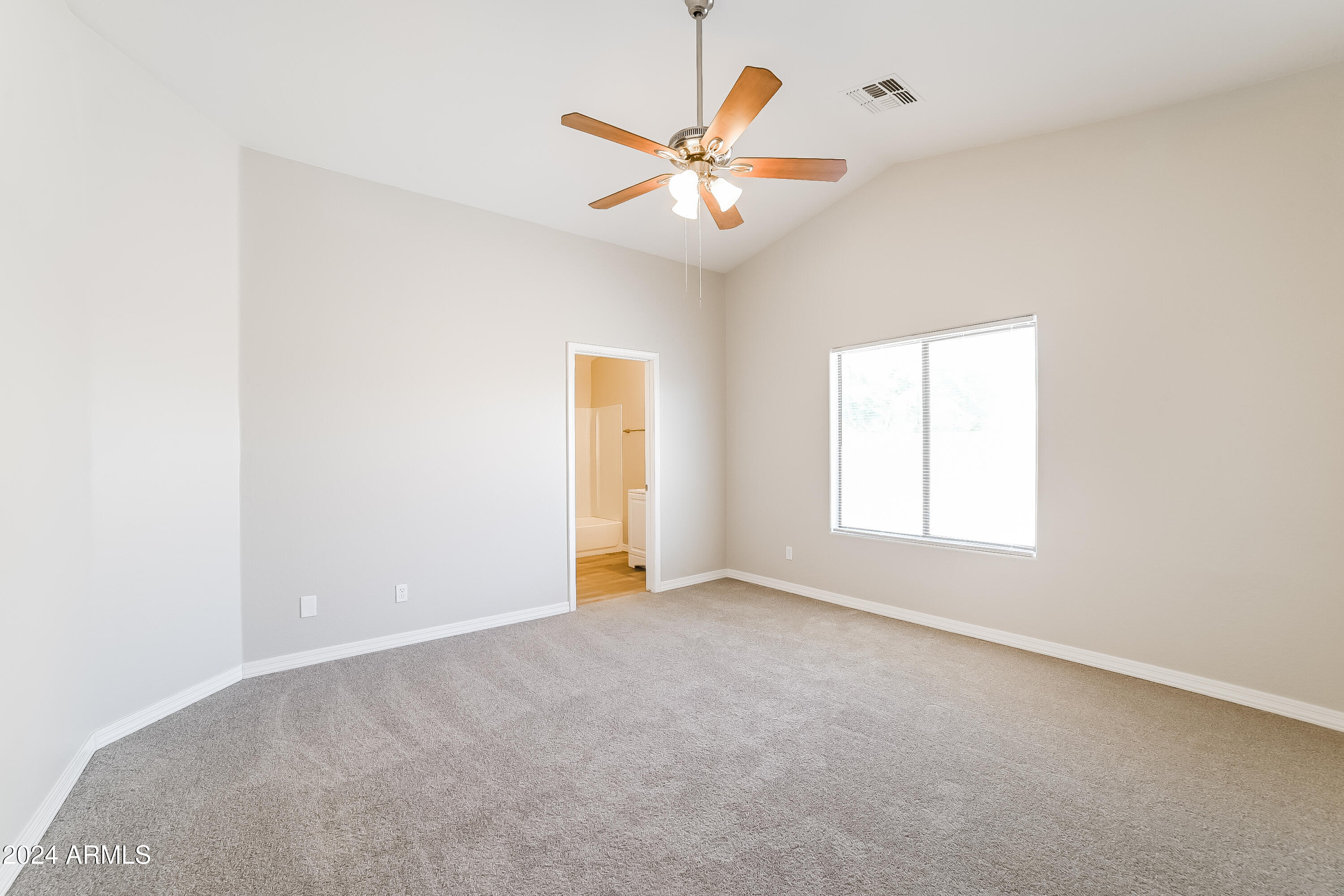 41402 Hopper Drive Maricopa, AZ 85138 - Photo 5 of 16 an empty room with window and ceiling fan