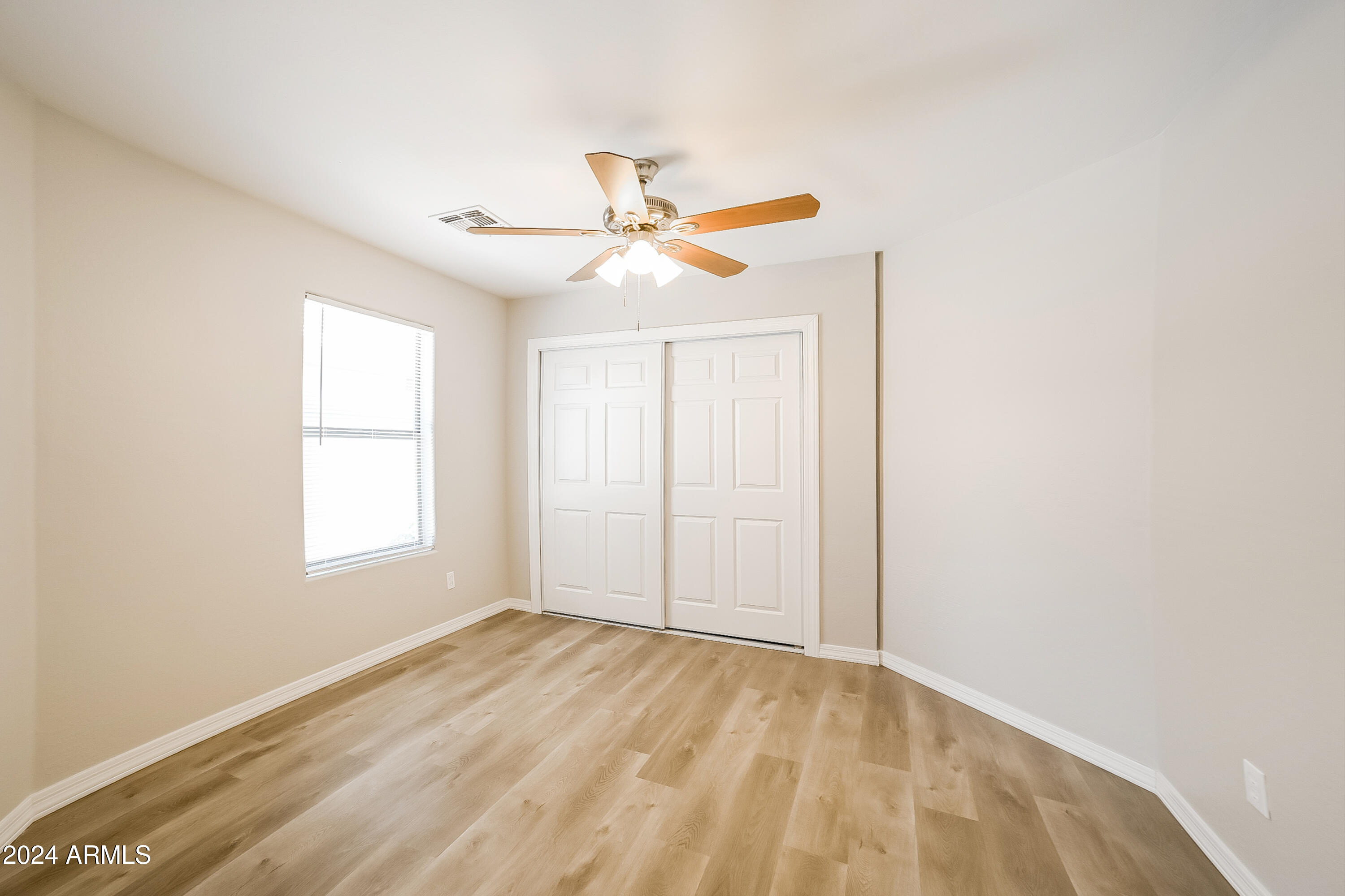 41402 Hopper Drive Maricopa, AZ 85138 - Photo 9 of 16 an empty room with a window and a ceiling fan