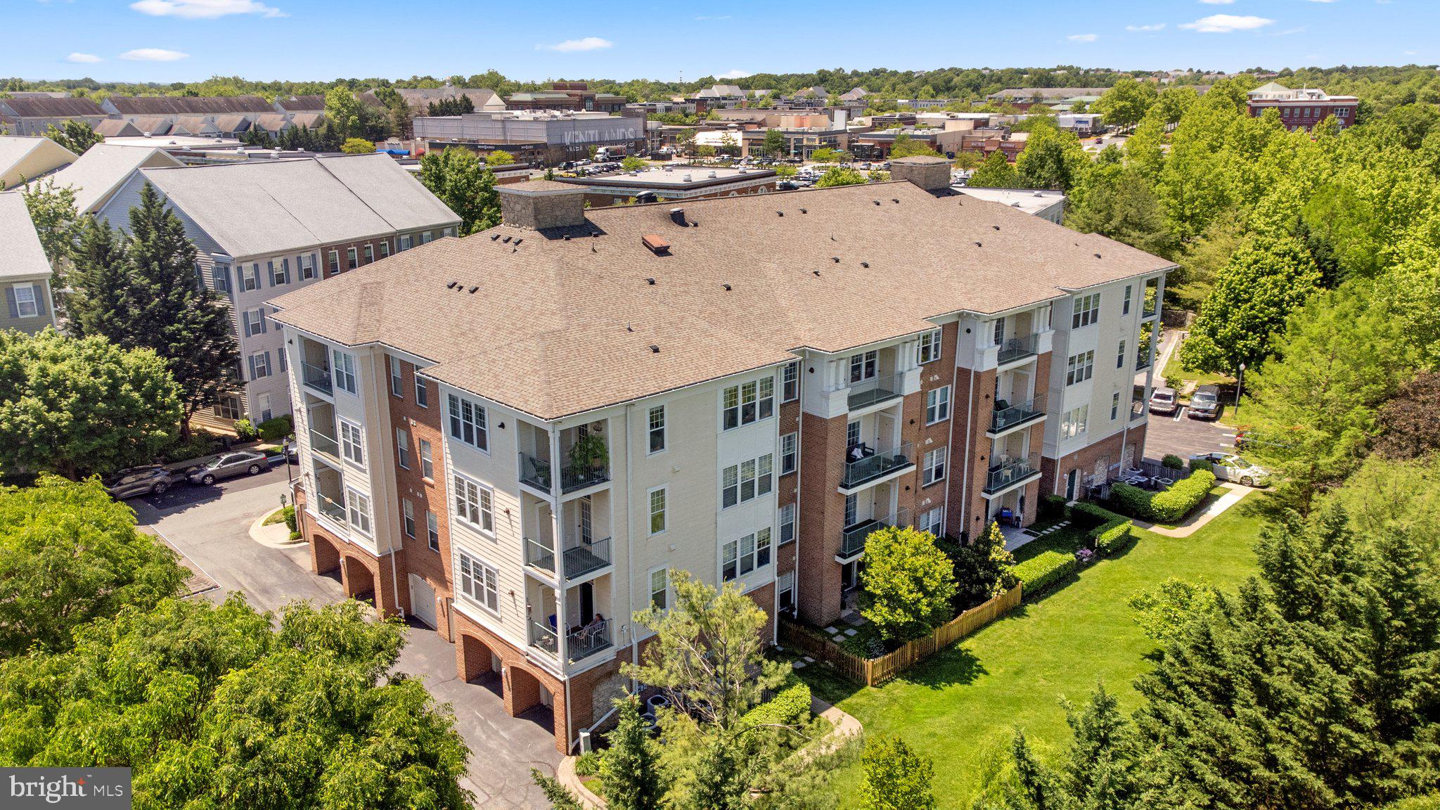 an aerial view of multiple houses with a yard