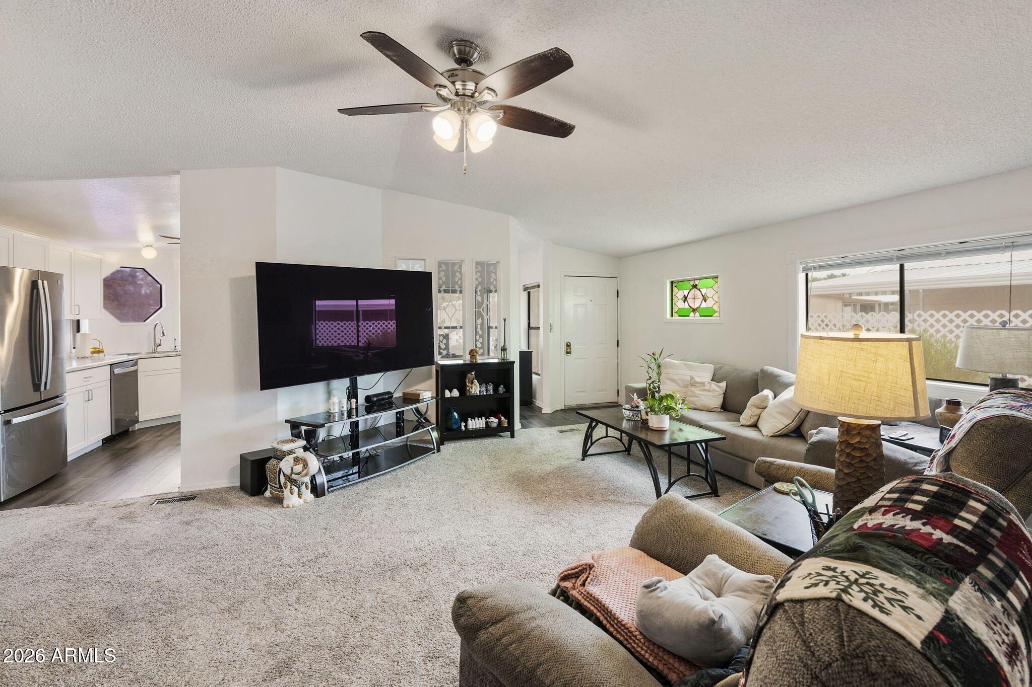 456 South 83rd Way Mesa, AZ 85208 - Photo 1 of 40 a living room with furniture a projector and a flat screen tv