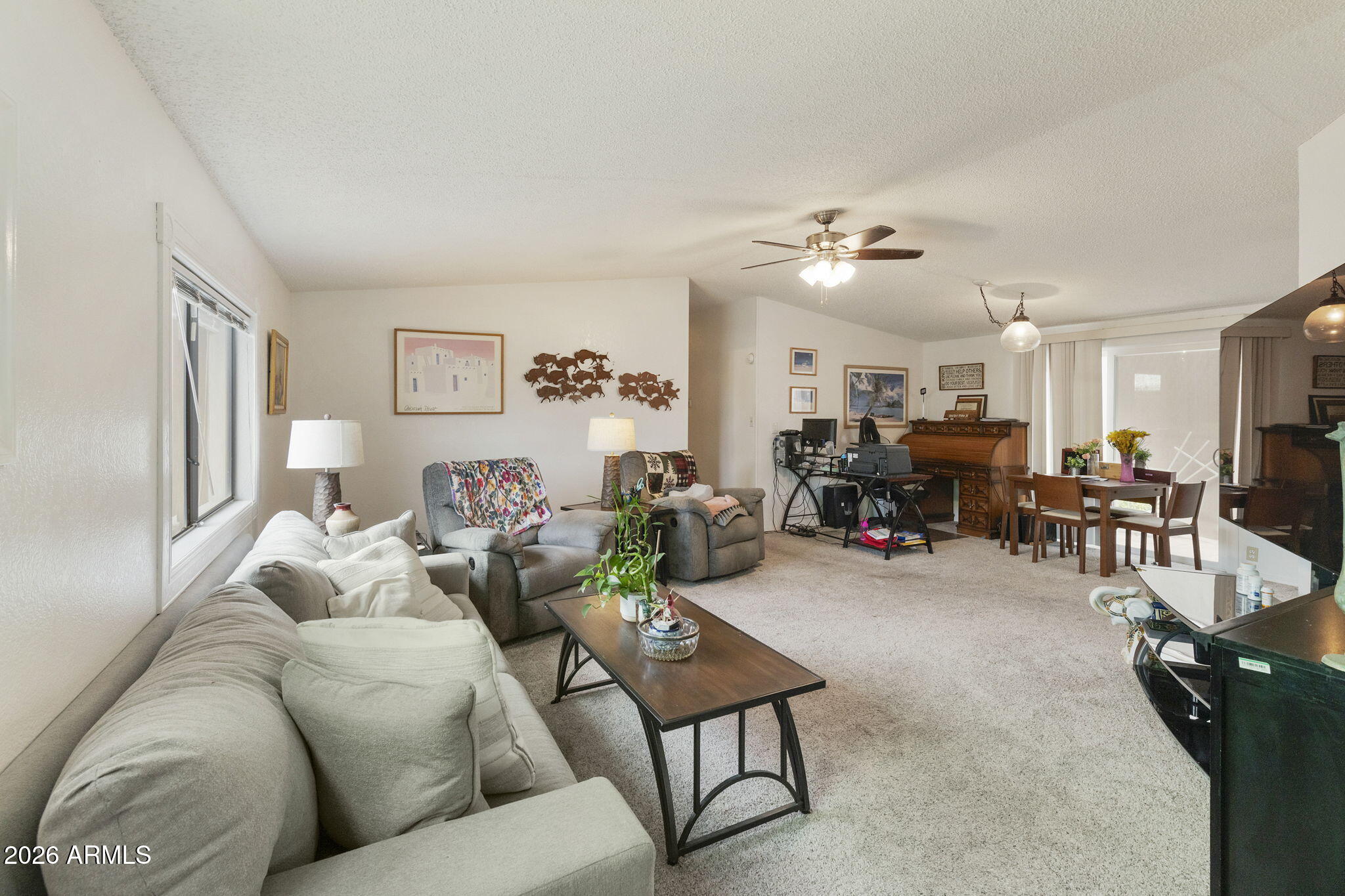 456 South 83rd Way Mesa, AZ 85208 - Photo 2 of 40 a living room with furniture and a chandelier