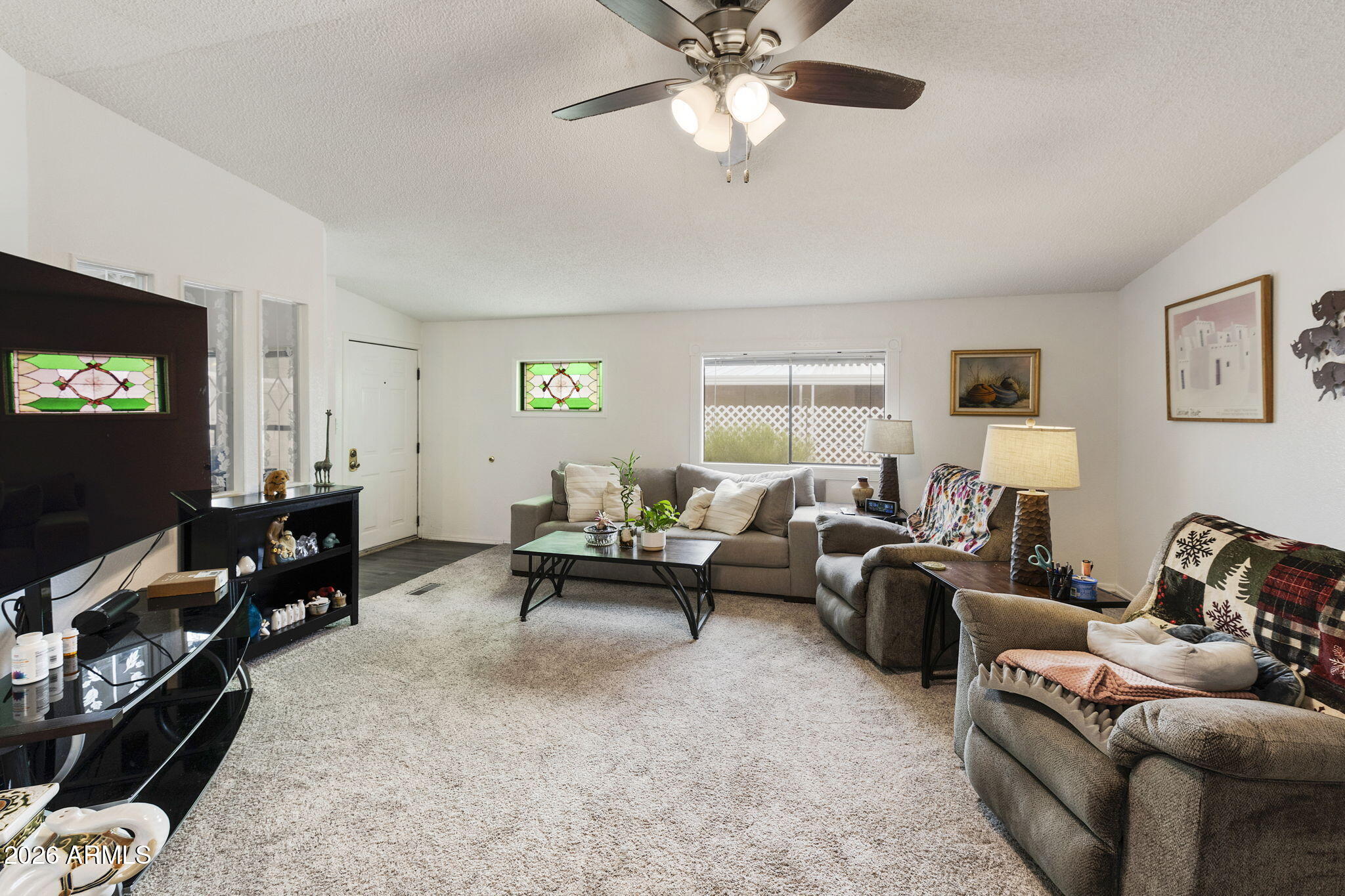 456 South 83rd Way Mesa, AZ 85208 - Photo 3 of 40 a living room with furniture and a flat screen tv