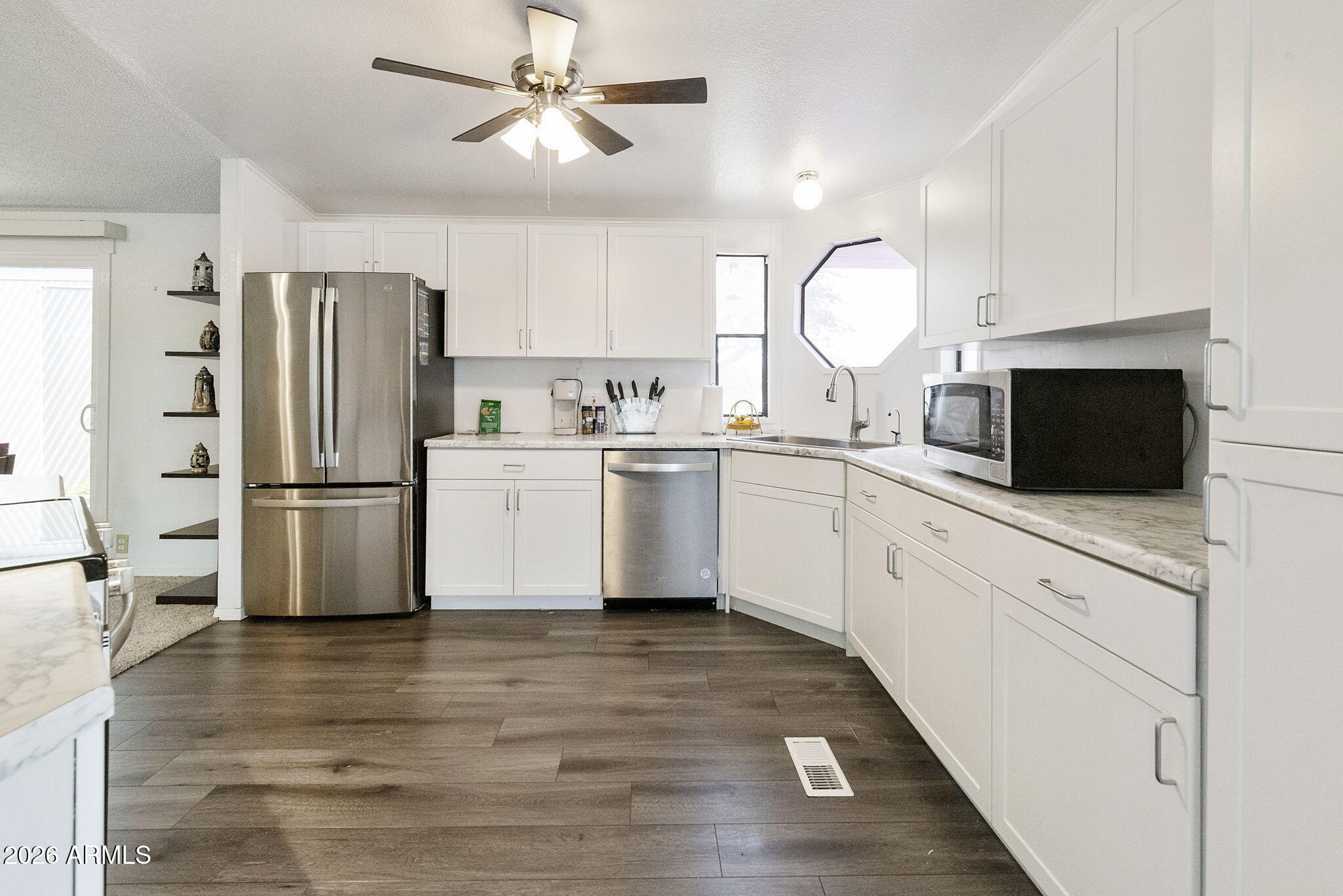 456 South 83rd Way Mesa, AZ 85208 - Photo 4 of 40 a kitchen with stainless steel appliances a refrigerator sink and microwave