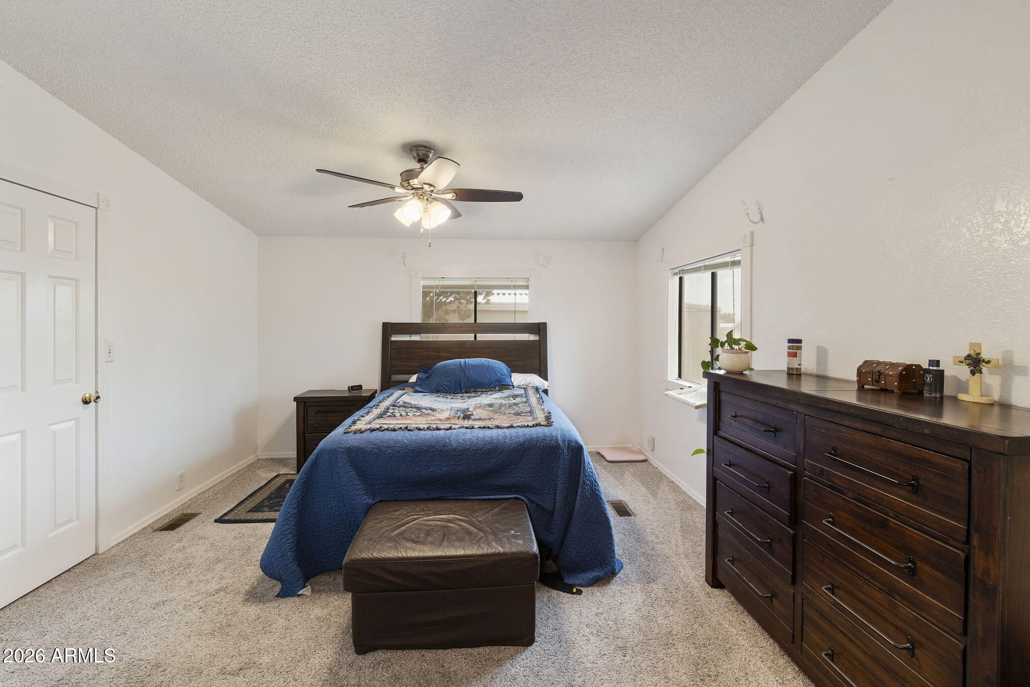 456 South 83rd Way Mesa, AZ 85208 - Photo 10 of 40 a bedroom with a bed and a chandelier